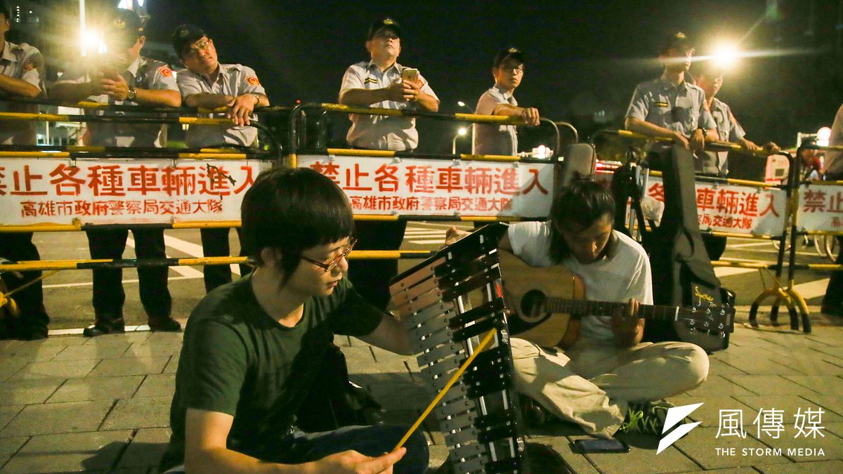 世大運閉幕,以彈唱倡台獨的團體在管制區唱給警察聽。(陳明仁攝) 世大運閉幕,以彈唱倡台獨的團體在管制區唱給警察聽。(陳明仁攝)