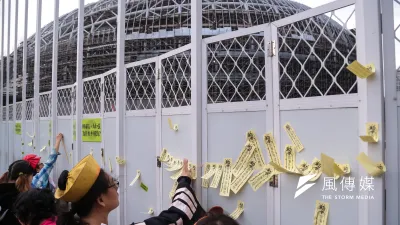 民團向台北高等行政法院提大巨蛋建照無效之訴,北高行今日判決有效,圖為去年10月多個民間團體30日舉行「不拆巨蛋就完蛋-2016萬聖節抓鬼大遊行」,並將寫有「拆蛋抓鬼,還我綠地」的標語符令貼於大巨蛋工地外牆上。(顏麟宇攝)