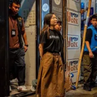 A female staff member of Hong Kong independent bookstore 'Lau Ha Book House' is handcuffed from behind by national security police. (Screenshot via RFA) A female staff member of Hong Kong independent bookstore 'Lau Ha Book House' is handcuffed from behind by national security police. (Screenshot via RFA)