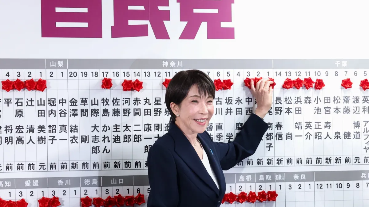 Japanese Prime Minister and LDP President Takaichi Sanae places victory flowers at party headquarters. (Associated Press)