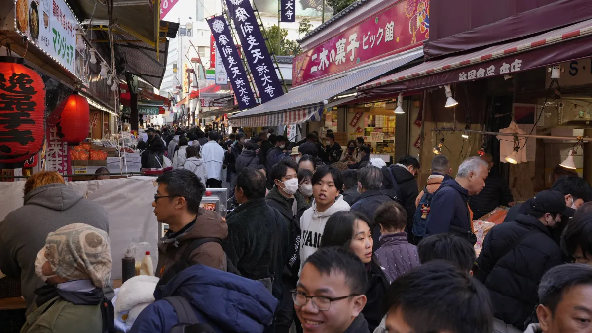 Shoppers crowd Tokyo's Ameyoko market street on December 31, 2024. From November 1, foreign visitors must pay Japan's consumption tax at the register and claim it back after customs confirms the goods are leaving the country. (AP)