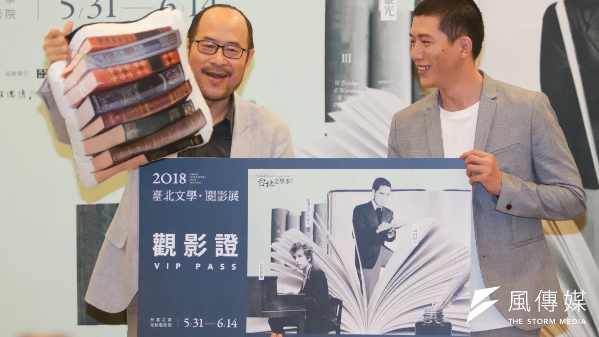 臺北文學.閱影展記者會,台北市文化局長鍾永豐(左)回贈觀影証及書籍抱枕給作家演員莫子儀(右),希望他不再「失眠」。(陳明仁攝)