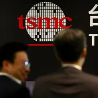 Attendees stand in front of a TSMC display at an industry event. (Photo: CNA) Attendees stand in front of a TSMC display at an industry event. (Photo: CNA)