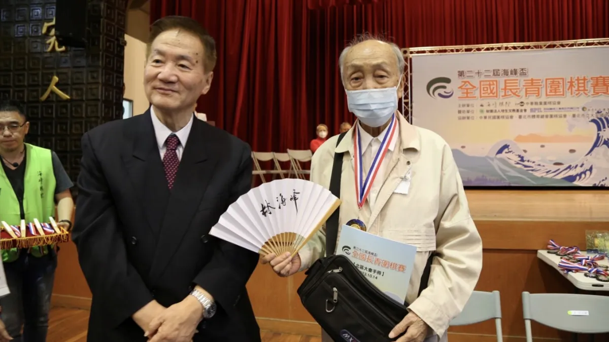 林海峰老師親自為高齡96歲的葉其明6段頒發「棋心不老」獎章。(海峰棋院)