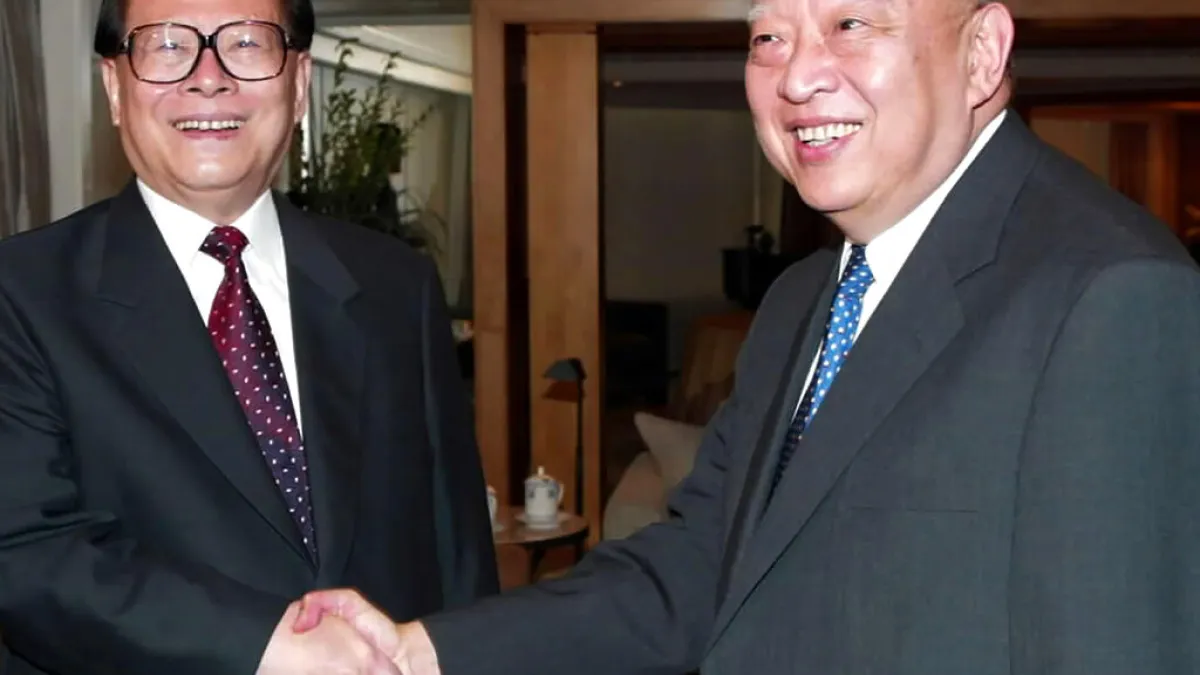 Then Chinese President Jiang Zemin (left) with Hong Kong Chief Executive Tung Chee-hwa in July 2002. (Photo by AP)