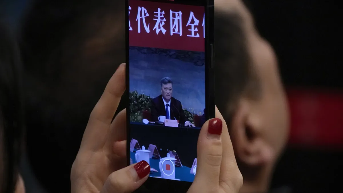 On March 7, 2024, journalists photograph Xinjiang Uyghur Autonomous Region Party Secretary Ma Xingrui as he delivers a work report. (AP)