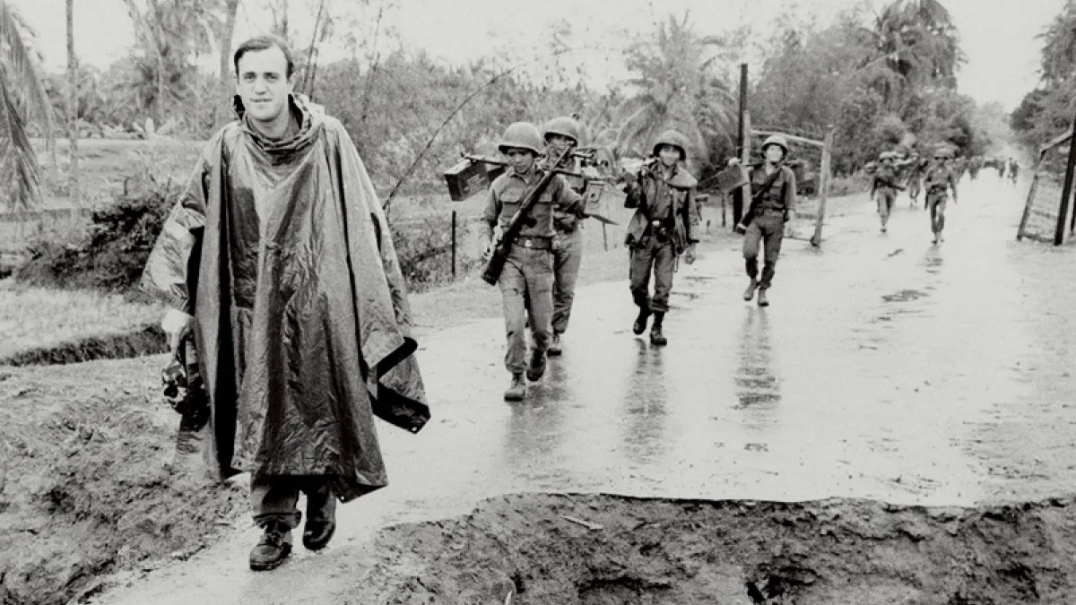 Renowned American war correspondent Peter Arnett (left) marching with Vietnamese troops on November 11, 1965 (AP)