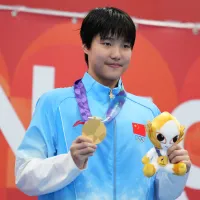 Yu Zidi celebrates after winning the women's 400-meter individual medley at the Aichi-Nagoya Asian Games, her third gold of the Games. (Associated Press) Yu Zidi celebrates after winning the women's 400-meter individual medley at the Aichi-Nagoya Asian Games, her third gold of the Games. (Associated Press)