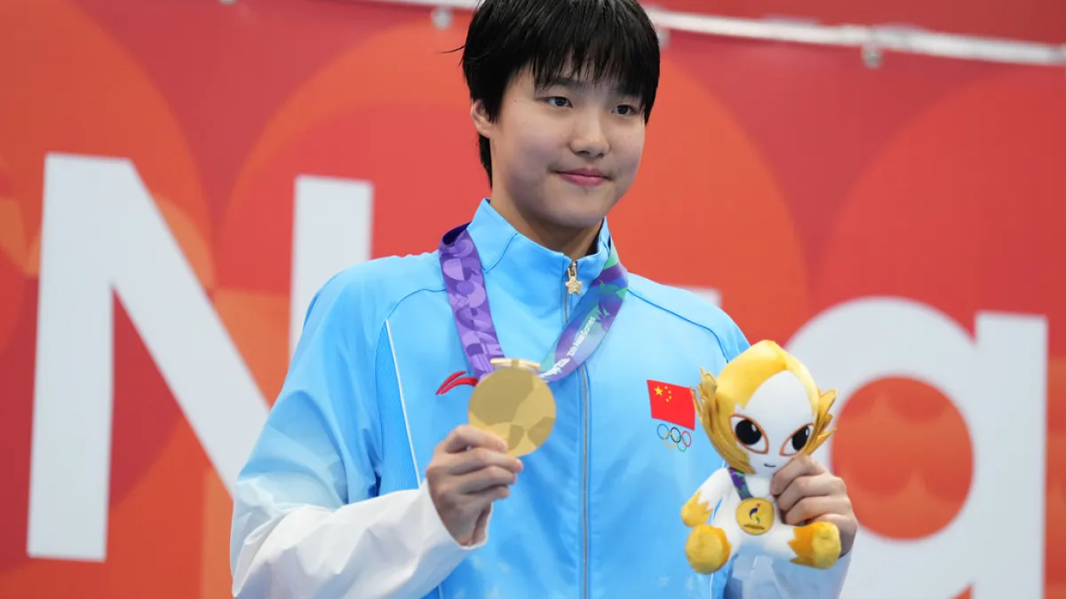 Yu Zidi celebrates after winning the women's 400-meter individual medley at the Aichi-Nagoya Asian Games, her third gold of the Games. (Associated Press)