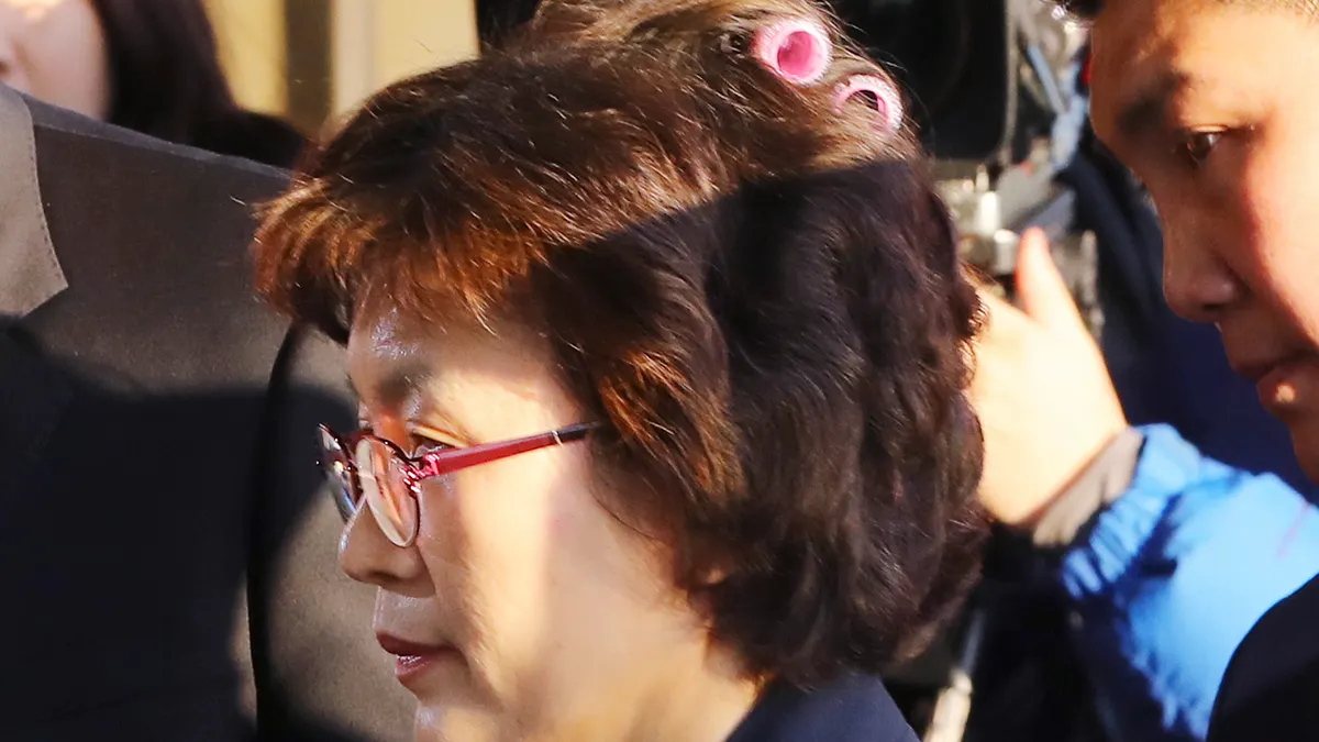 南韓憲法法院10日宣判朴槿惠總統彈劾案,代院長李貞美進場時忘記拿下髮捲(AP) 南韓憲法法院10日宣判朴槿惠總統彈劾案,代院長李貞美進場時忘記拿下髮捲(AP)