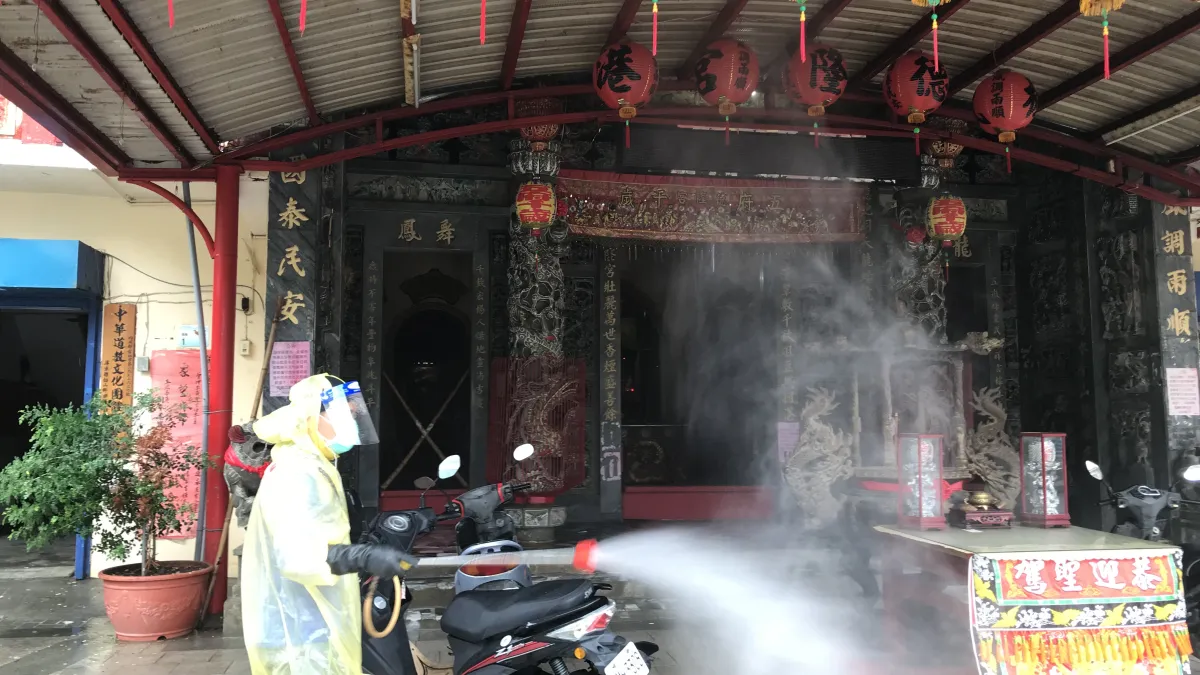 屏東枋山出現印度Delta變異株感染案例,縣府派出人員於該社區德隆宮進行消毒。(屏東縣政府提供)