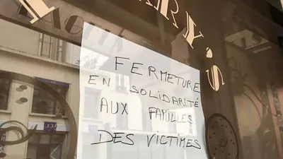 巴黎一家小餐廳打出手寫告示:為了與罹難者家屬保持團結,暫停營業。(BBC中文網)