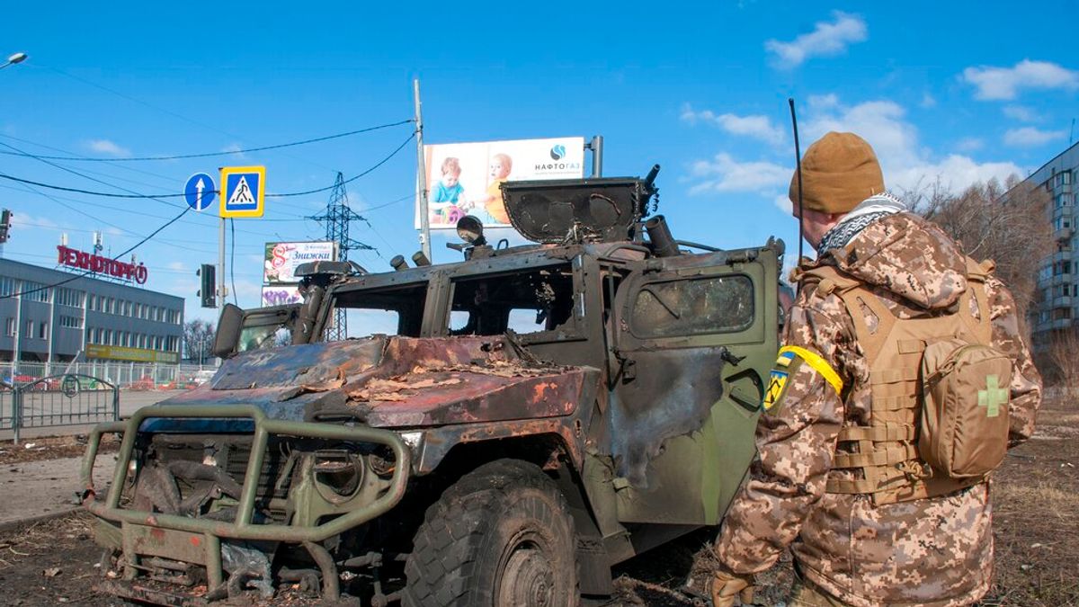 哈爾基夫一名烏克蘭士兵正在查看遭到炸毀的軍車。(美聯社) 哈爾基夫一名烏克蘭士兵正在查看遭到炸毀的軍車。(美聯社)