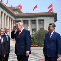 U.S. President Donald Trump and Chinese Defense Minister Dong Jun exchange military salutes on May 14, 2026. (AP) U.S. President Donald Trump and Chinese Defense Minister Dong Jun exchange military salutes on May 14, 2026. (AP)
