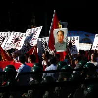 Protesters in Beijing march holding a portrait of Mao Zedong during the 2012 Diaoyu Islands dispute. Sculptor Gao Zhen's satirical depictions of the chairman have now earned him three years in prison. (AP) Protesters in Beijing march holding a portrait of Mao Zedong during the 2012 Diaoyu Islands dispute. Sculptor Gao Zhen's satirical depictions of the chairman have now earned him three years in prison. (AP)