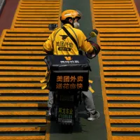 A Meituan food delivery courier on the streets of Beijing, September 2022. (AP) A Meituan food delivery courier on the streets of Beijing, September 2022. (AP)