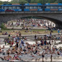 Residents seek shade along the Isar River near Reichenbach Bridge in Munich, Germany. (AP) Residents seek shade along the Isar River near Reichenbach Bridge in Munich, Germany. (AP)