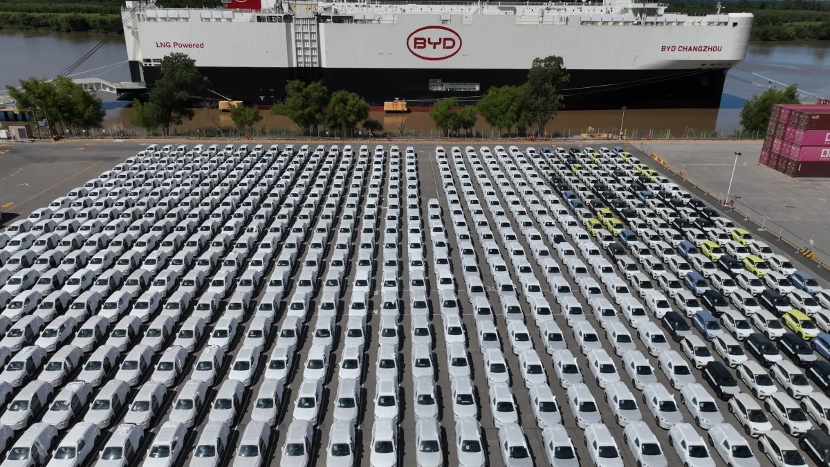 A BYD car-carrier vessel docks at Zárate port near Buenos Aires, Argentina, on Jan. 20, 2026, with rows of BYD electric and hybrid vehicles lining the shore. (AP)