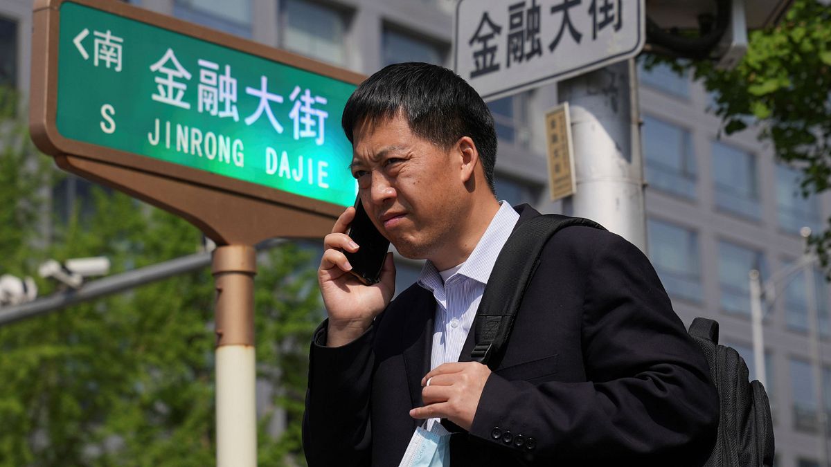 北京上班族經過金融大街。(美聯社) 北京上班族經過金融大街。(美聯社)