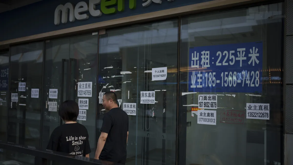 2024年7月2日。在中國北京的一家購物中心,一名男子走過空蕩的商店前。(美聯社)