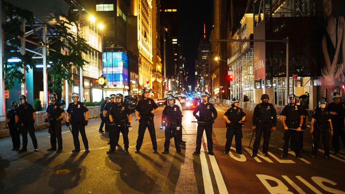 紐約警察5月31日川普大廈外的第五大道上排成一線,阻擋抗議者繼續前進。(美聯社) 紐約警察5月31日川普大廈外的第五大道上排成一線,阻擋抗議者繼續前進。(美聯社)