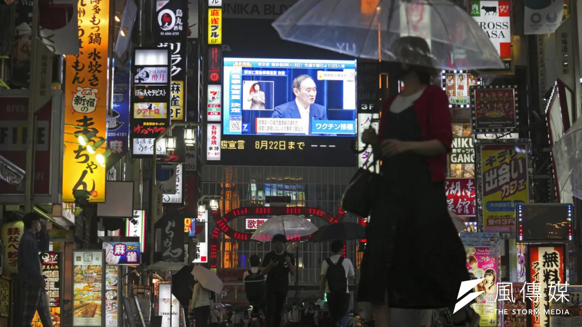 東京鬧區街頭的大螢幕上,正在播放菅義偉宣布東京將在7月12日進入第四波緊急事態的記者會。(美聯社)