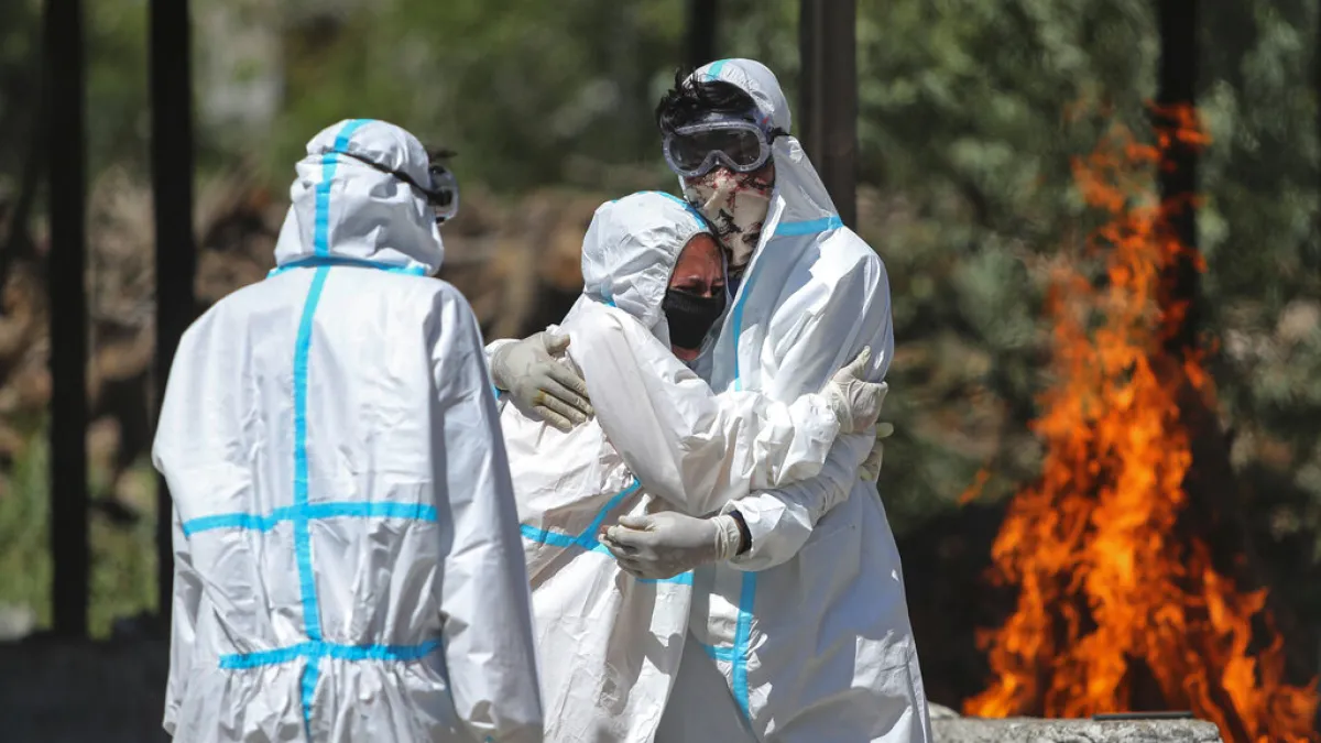 死亡病例湧入讓印度的火葬場不堪負荷,遺體與家屬只得排隊等候。(美聯社)