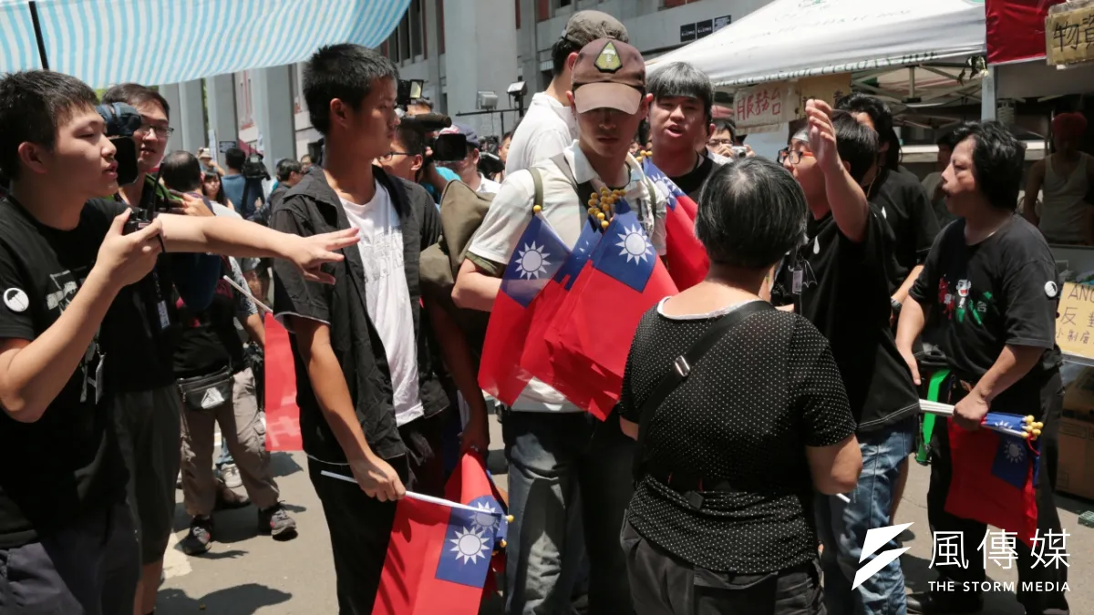 王炳忠與統派人士4日赴教育部前發國旗,被反課綱學生轟出場。(余志偉攝)