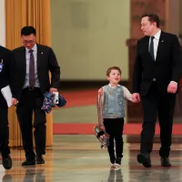 Tesla CEO Elon Musk, right, arrives with his son X Æ A-Xii for the meeting between Chinese Premier Li Qiang and U.S. business representatives, at the Great Hall of the People in Beijing, May 14, 2026. (AP) Tesla CEO Elon Musk, right, arrives with his son X Æ A-Xii for the meeting between Chinese Premier Li Qiang and U.S. business representatives, at the Great Hall of the People in Beijing, May 14, 2026. (AP)