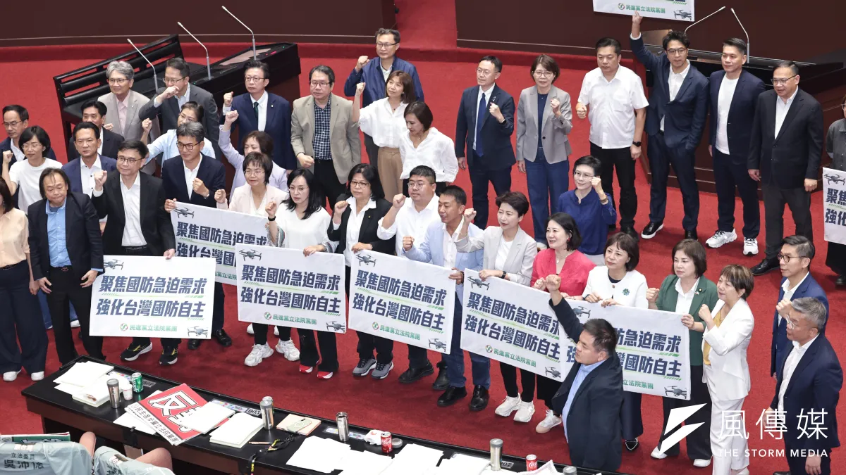 立法院27日三讀通過國防自主無人載具採購特別條例,民進黨團舉牌表達立場。(顏麟宇攝)