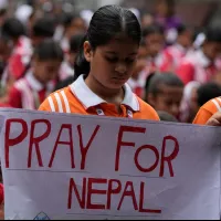 Students in Jammu, India, hold placards in prayer for victims of the August 26 flash flood that devastated communities along the Nepal-China border, killing more than 800 people. (AP) Students in Jammu, India, hold placards in prayer for victims of the August 26 flash flood that devastated communities along the Nepal-China border, killing more than 800 people. (AP)