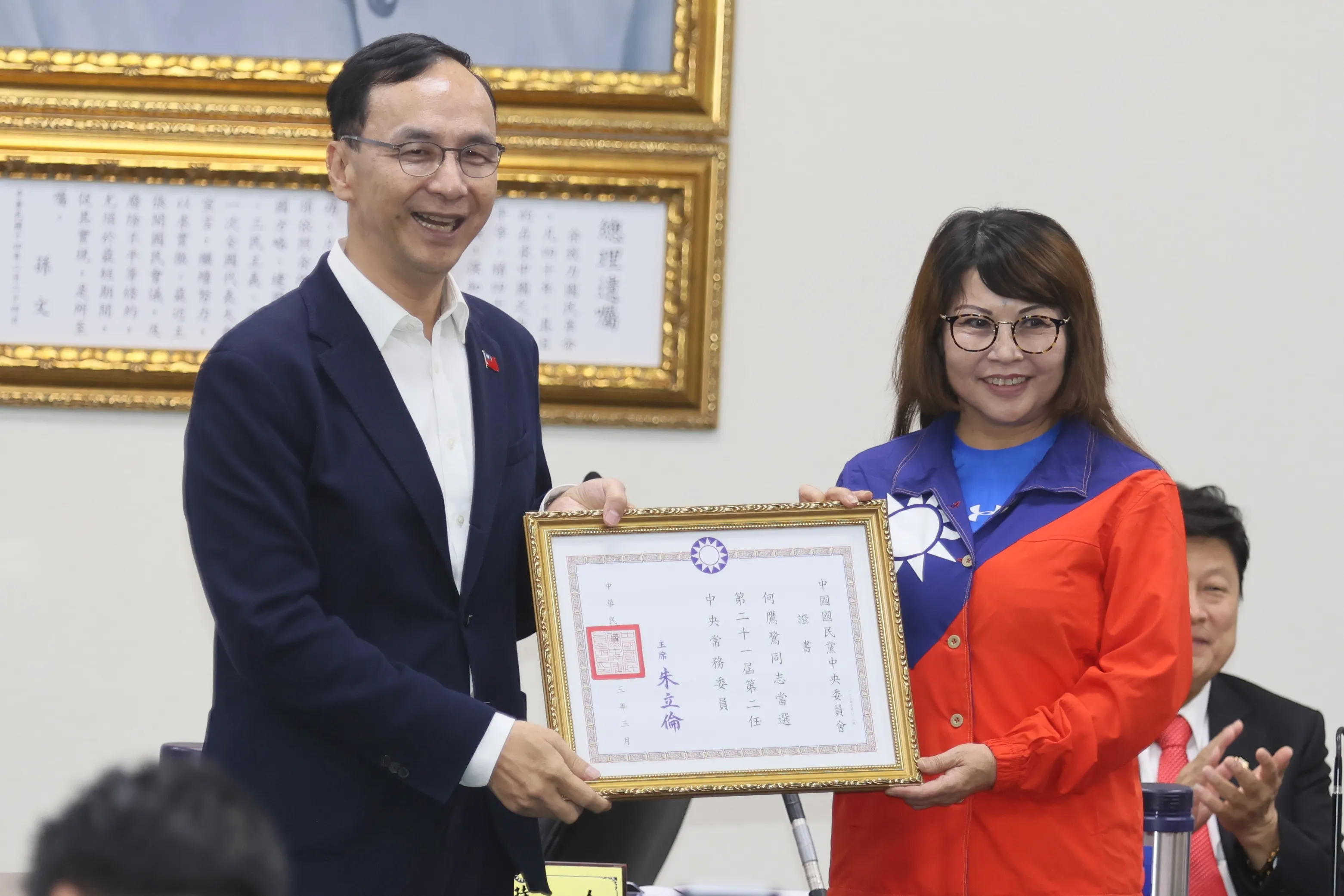 國民黨主席朱立倫（左）13日在國民黨中常會頒給新任中常委何鷹鷺（右）等人證書。（柯承惠攝）
