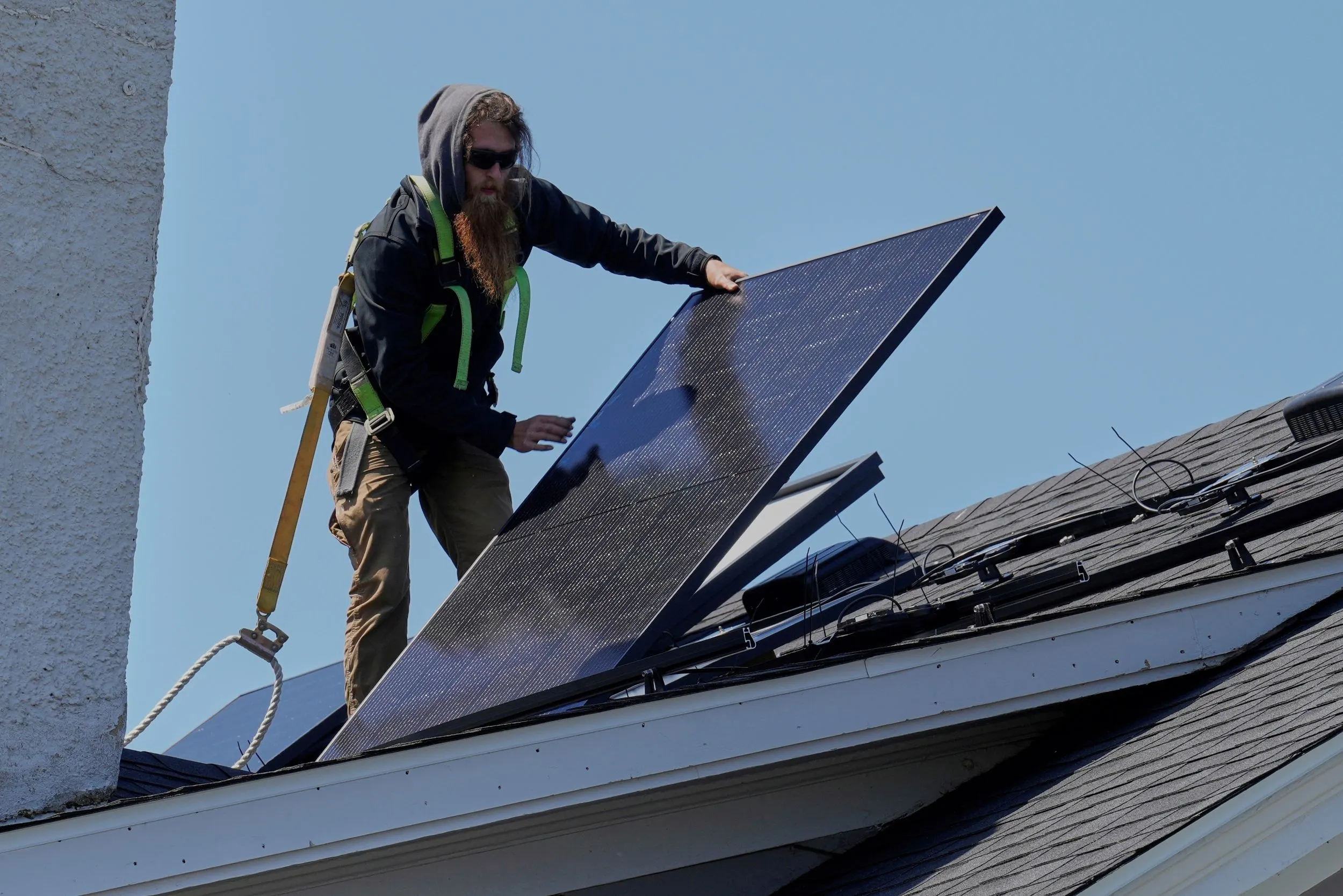美國俄亥俄州工人替住家裝設太陽能發電組。（美聯社）