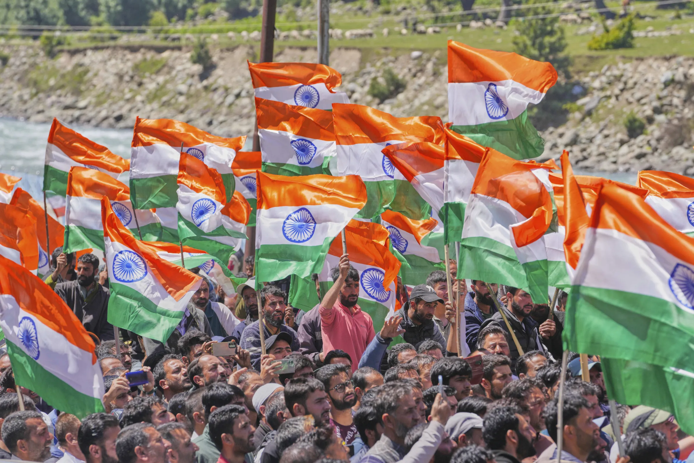 Indian citizens wave national flags.