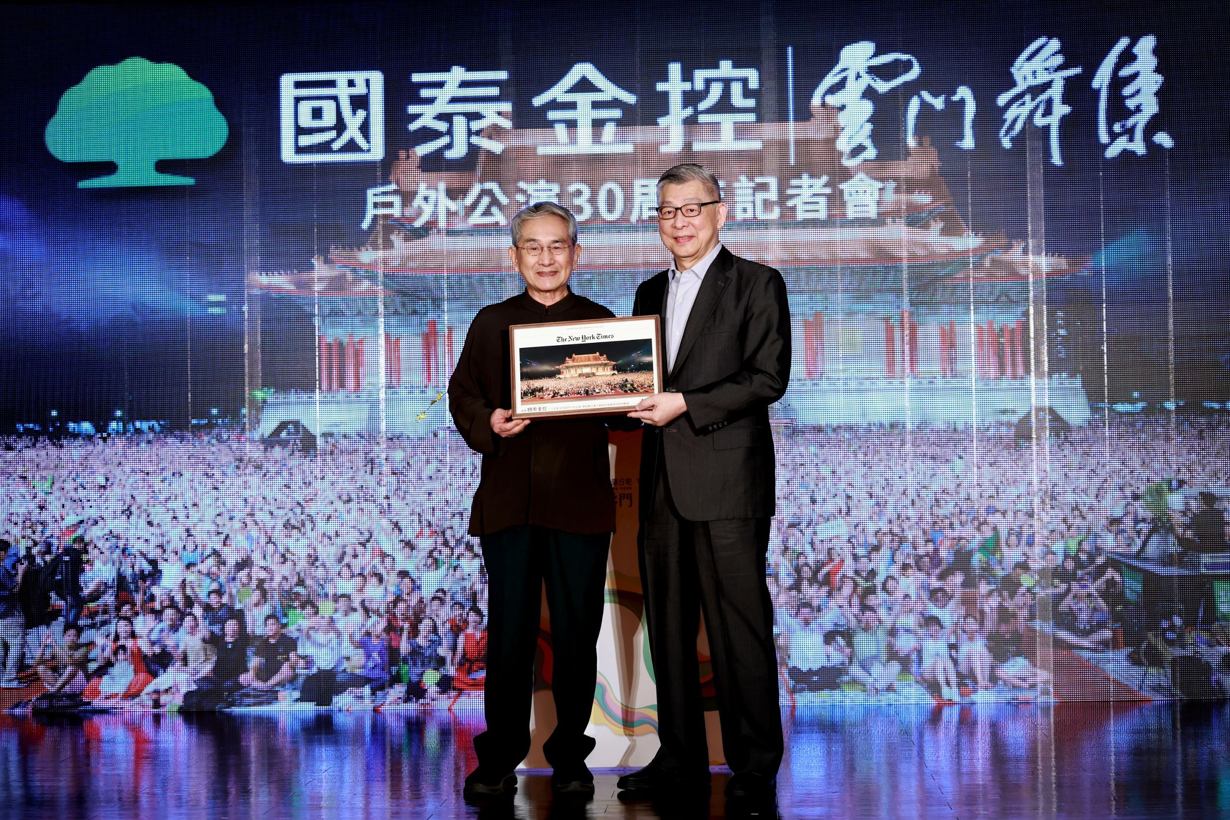 20250715－雲門舞集創辦人林懷民（左）致贈2019年國泰雲門戶外公演登上美國紐約時報的照片裱框予國泰金控董事長蔡宏圖（右）。（國泰金控提供）