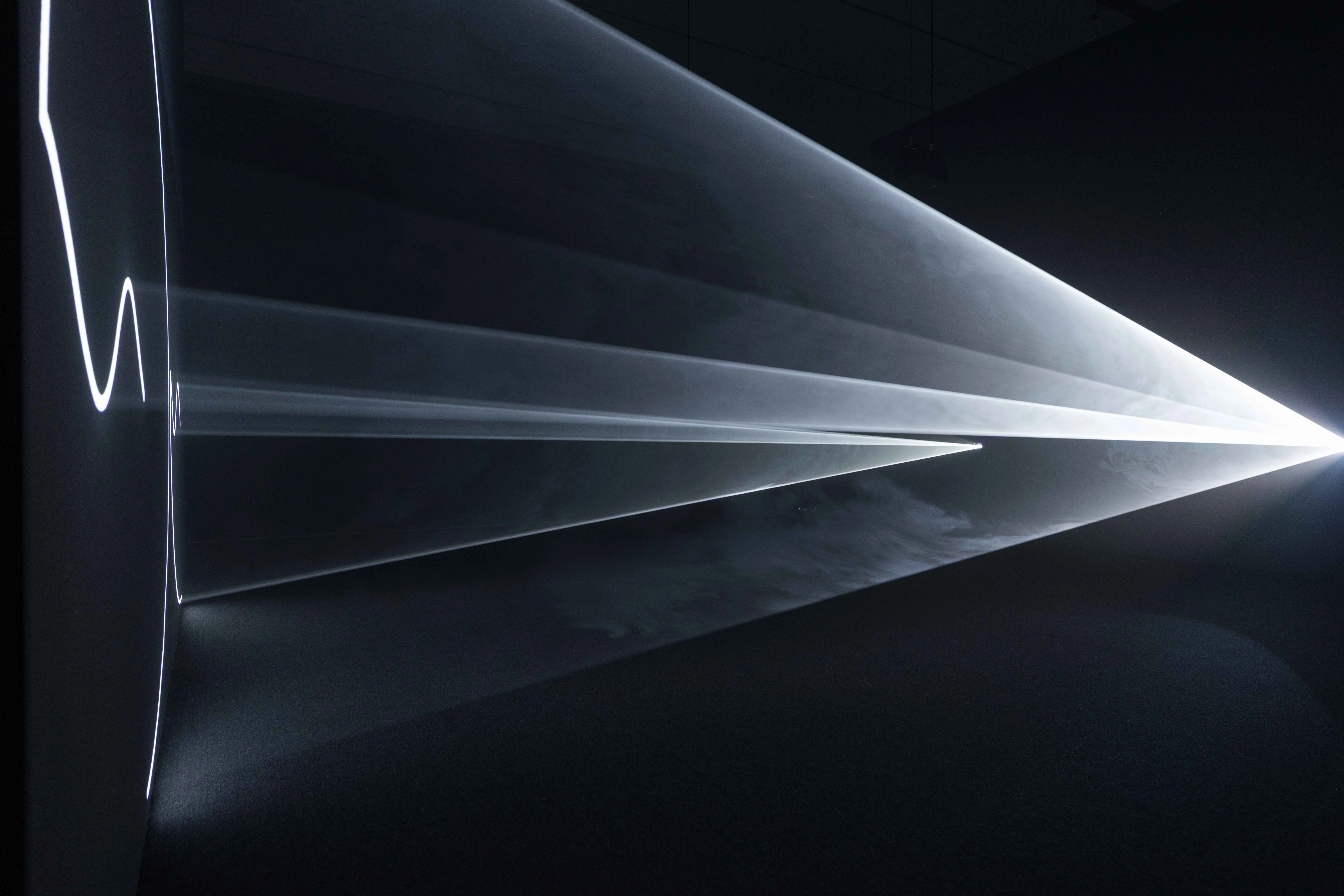 20250725-當觀眾置身於黑暗空間中,在煙霧的輔助下,眼前的三維形體將更加清晰浮現,彷彿一座由光構成的雕塑。圖中作品為「離去(靜默兩分鐘)」(Leaving (With Two-Minute Silence))。(富邦美術館提供)