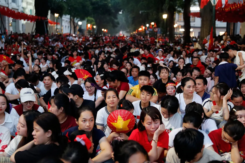 越南民眾揮舞國旗，並穿戴各種國徽或特別圖騰象徵上街，慶祝獨立80週年。（美聯社）