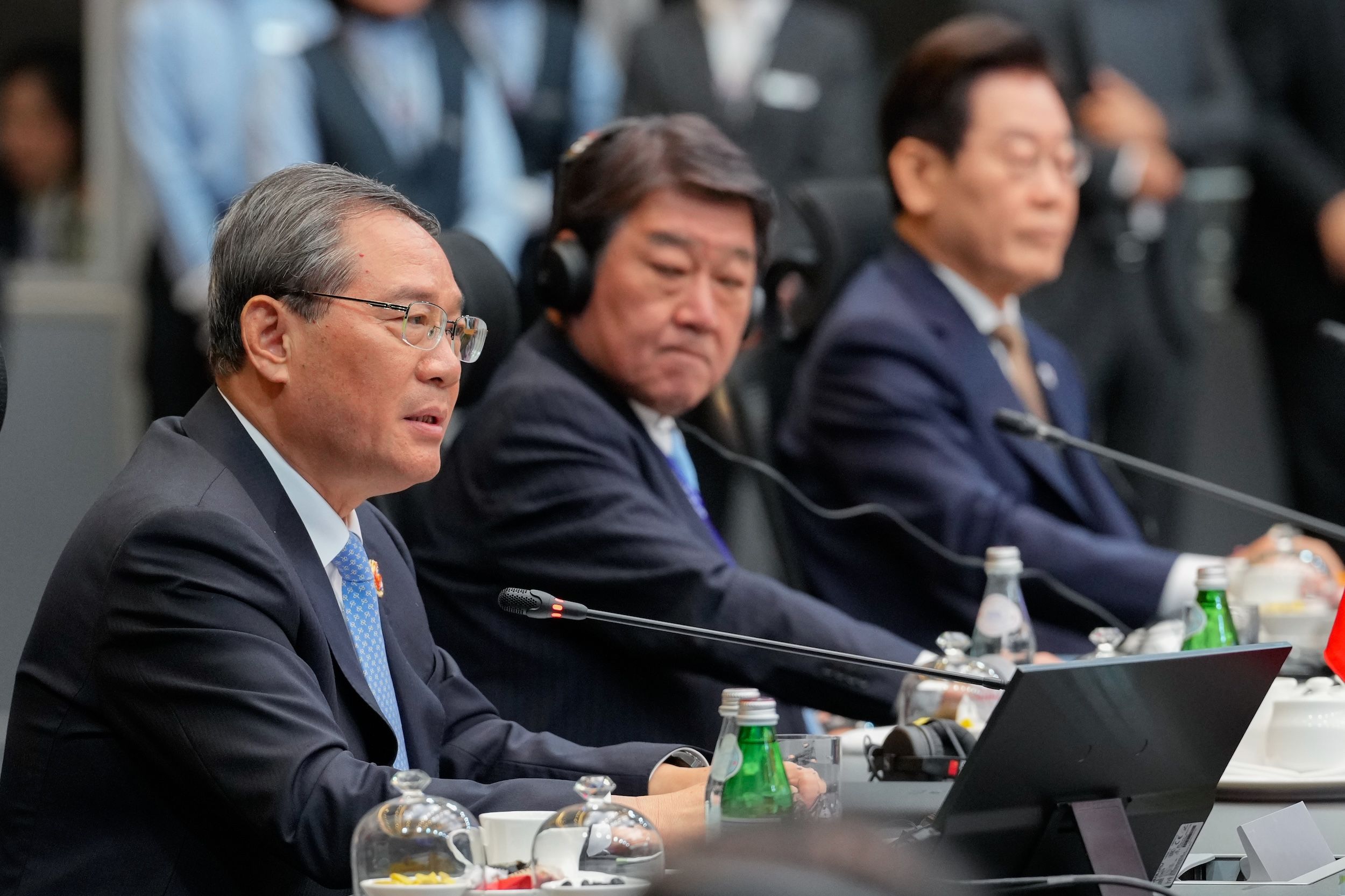 2025年10月27日，中國國務院總理李強在第28屆東盟加三峰會致詞，一旁是日本外務大臣茂木敏充與韓國總統李在明。（美聯社）