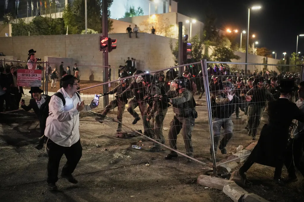 超過十萬名以色列正統派教徒湧入耶路撒冷街頭，抗議政府強制徵兵的決定，還跟現場警察發生衝突。（美聯社）