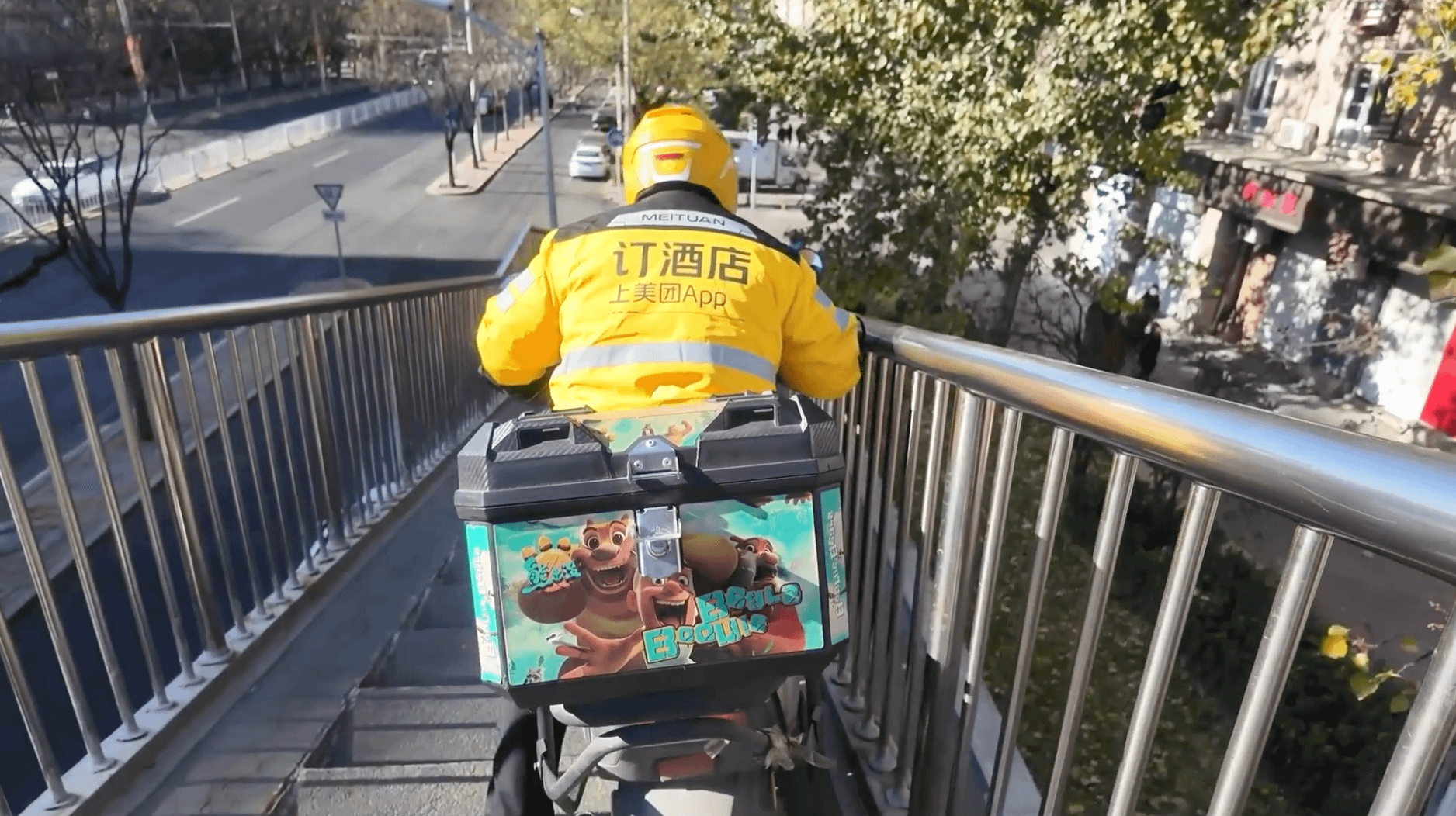 美團一名外送騎手穿行北京一座過街天橋。