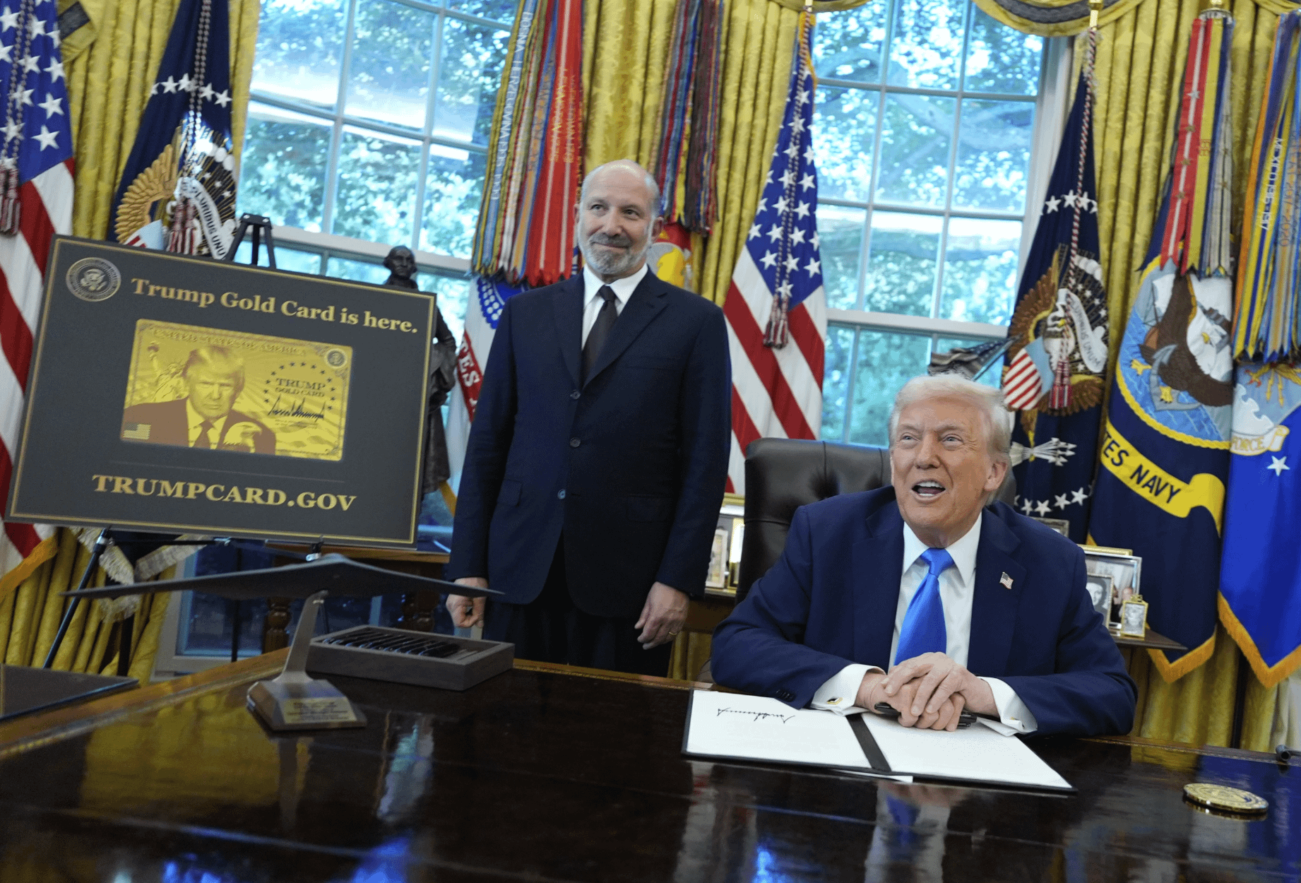 美國總統川普與商務部長盧特尼克介紹「川普金卡」的簽證快速通關計畫。（美聯社）