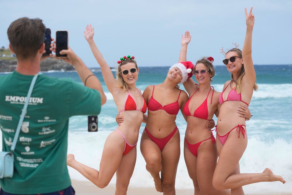地處南半球的澳洲，民眾穿著比基尼迎接「夏天版本」聖誕節。（美聯社）