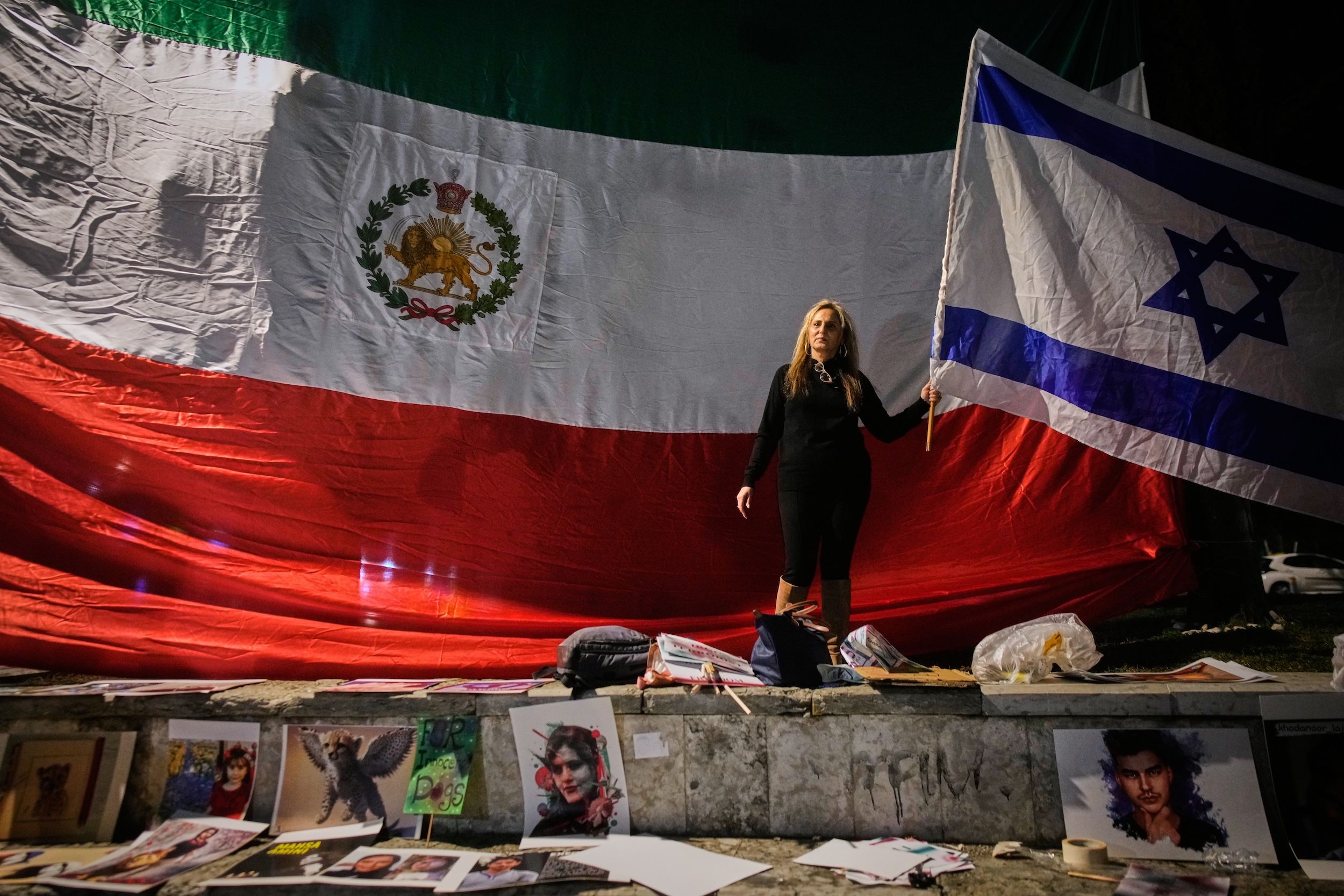 2026年1月14日、イスラエルでイラン反政府抗議デモに連帯を示すデモ参加者。イスラエル国旗を掲げ、背後には旧イラン国旗が見える。（AP）