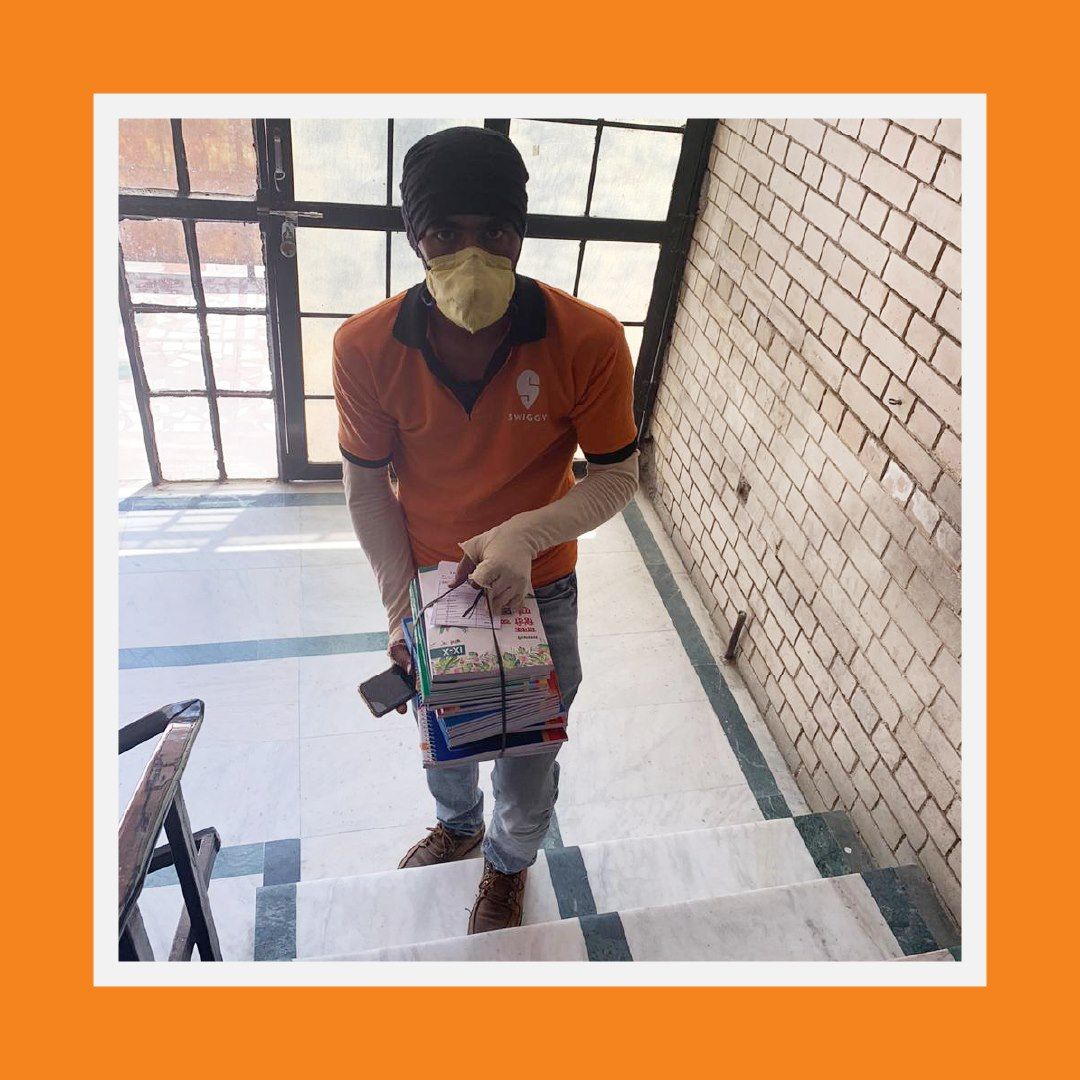 印度知名外送平台Swiggy人員將書籍送達目的地。（翻攝自官方粉專）