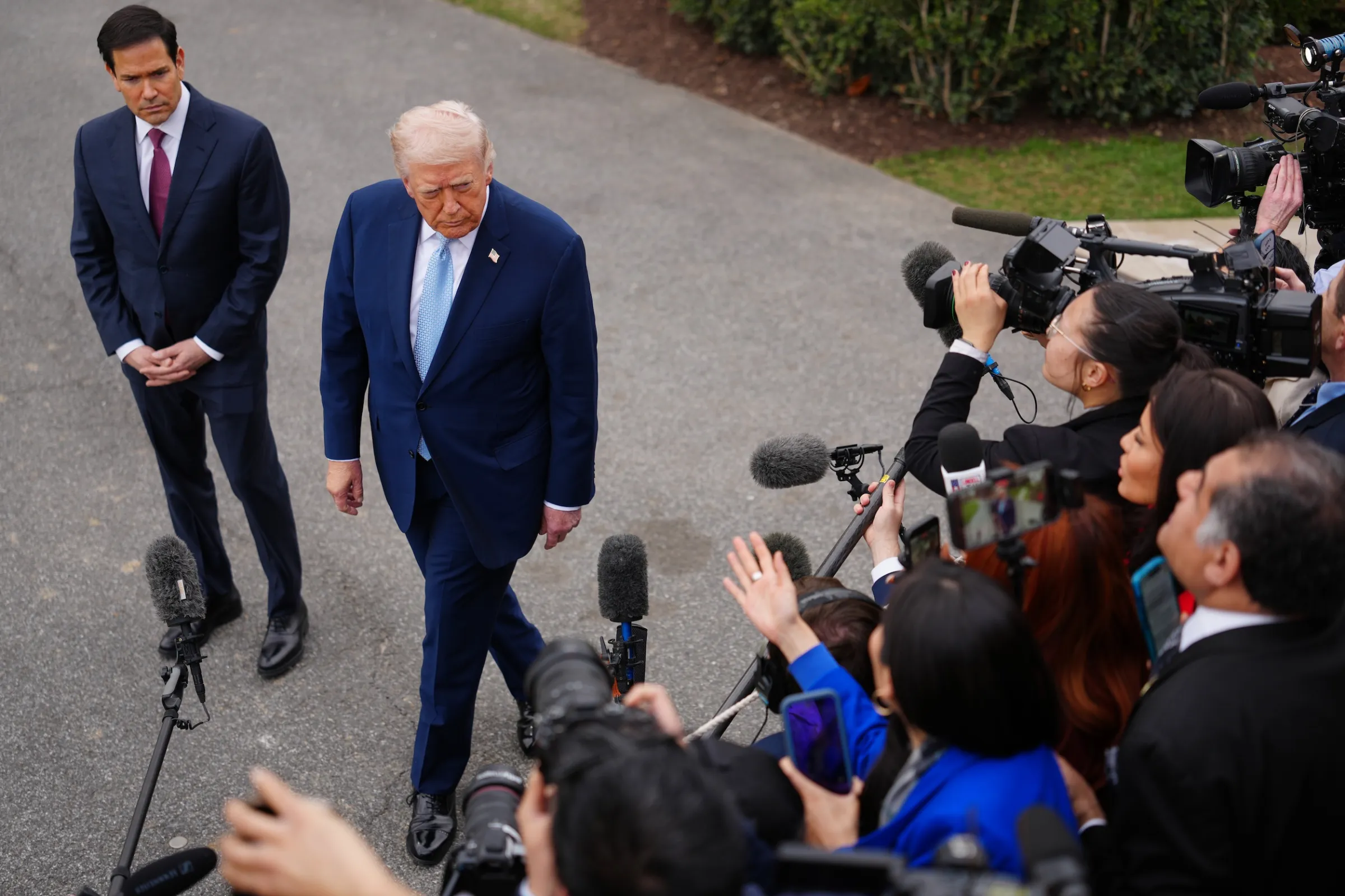 On March 20, 2026, U.S. President Donald Trump speaks with reporters on the South Lawn of the White House, with Secretary of State Marco Rubio at his side. (Associated Press)