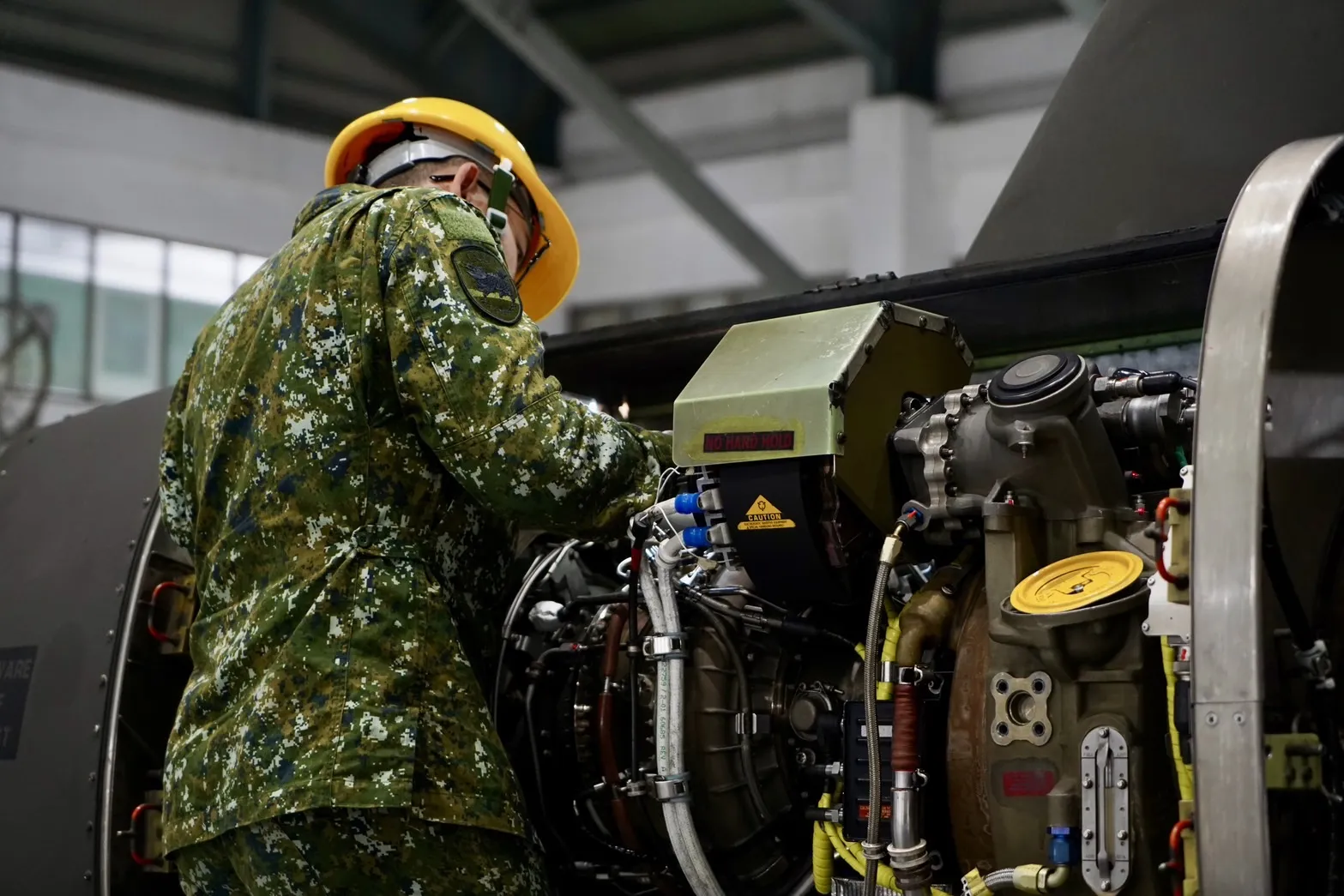 AABSF personnel dismantling a helicopter for inspection.
