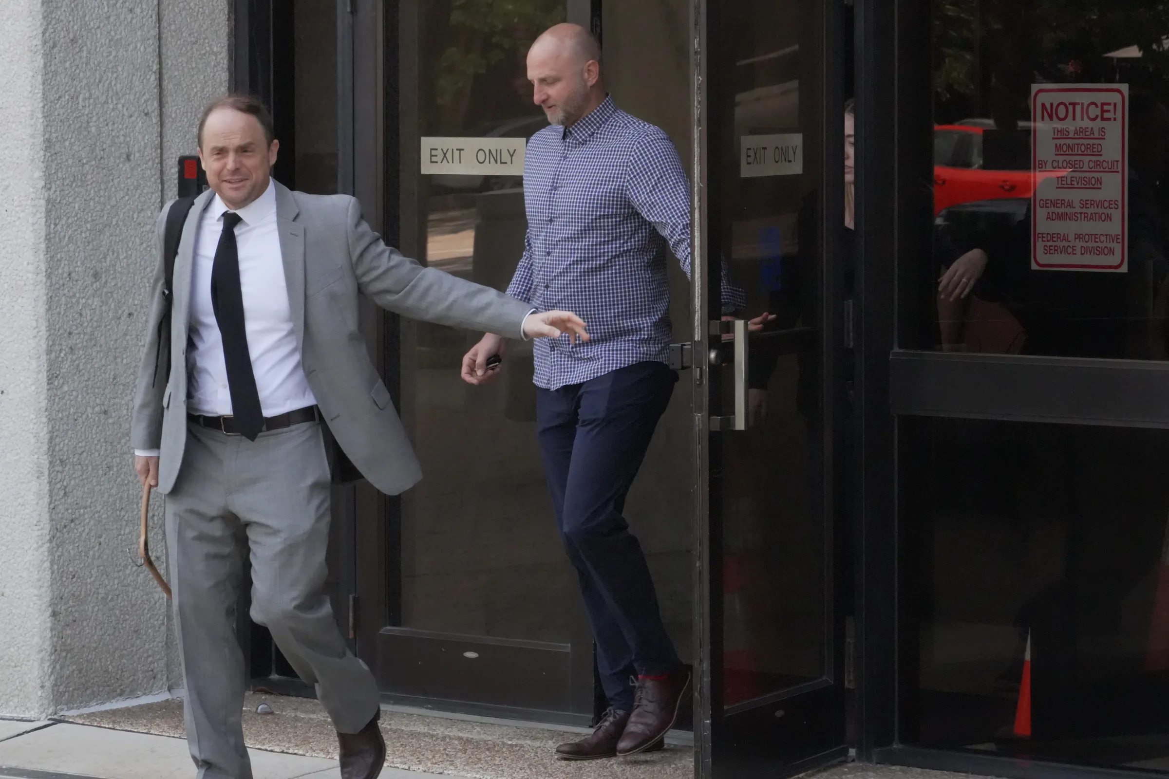 Assistant U.S. Attorney Logan Liles, left, leaves the federal courthouse in Raleigh, N.C., on Friday, April 24, 2026, during the