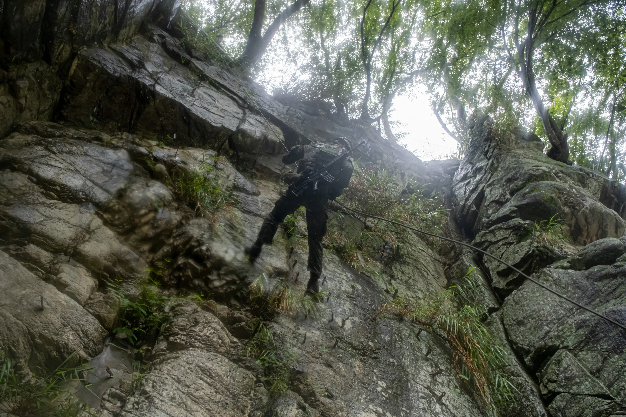 Trainees navigate difficult terrain along the Dajia River on June 11, 2026.