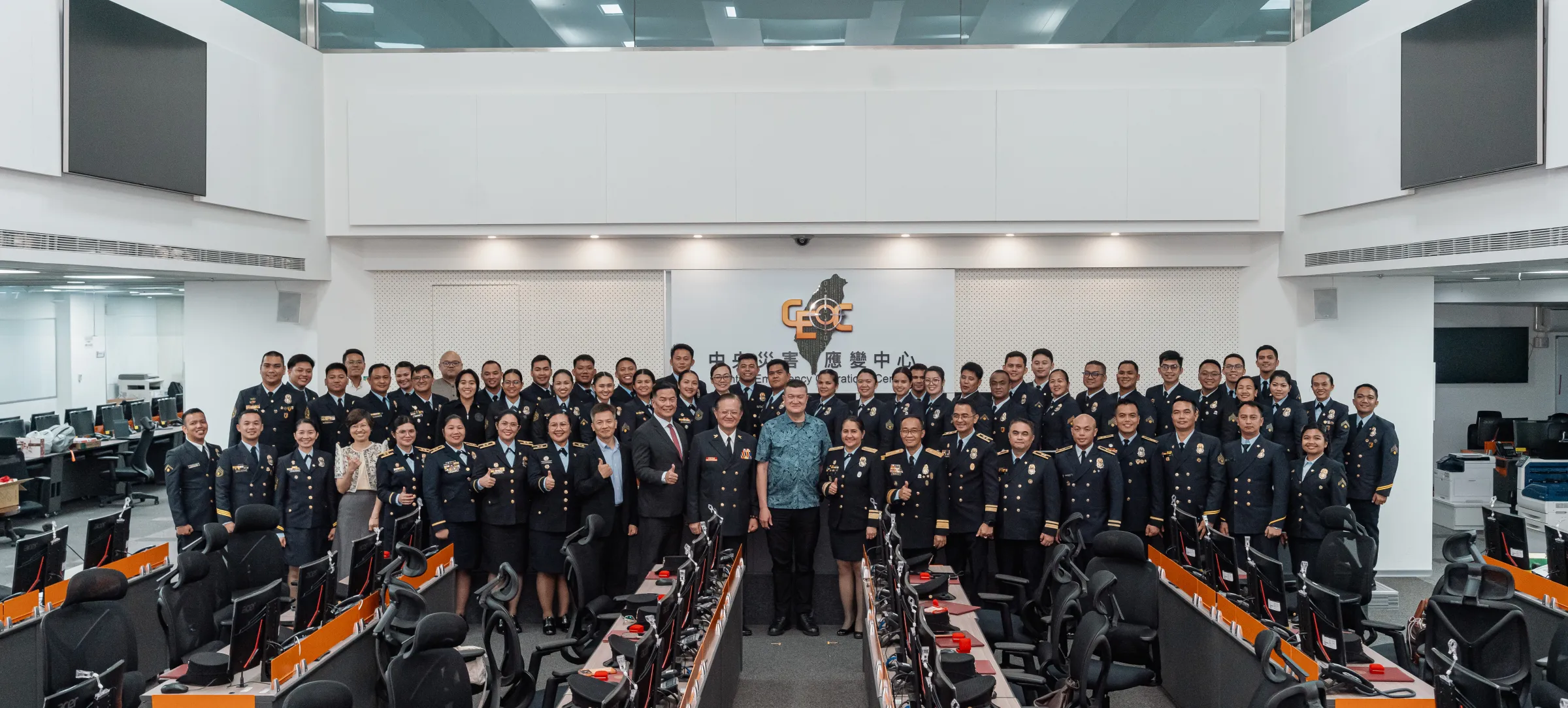 Taiwanese and Philippine officials pose with the 54 graduating firefighters at Taiwan's Central Emergency Operation Center. (Provided by TAEF)