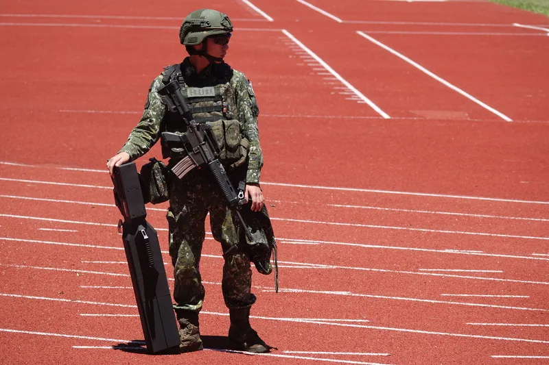 ROC Army soldiers carry drone jamming rifles during a defence equipment display at National Central University, July 2026